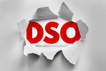 DSO acronym bursts through torn paper with the words “Days Sales Outstanding” beneath. Concept...
