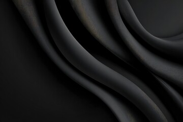 Fototapeta premium Flowing dark grey fabric drapes and curves across the frame creating a smooth elegant texture