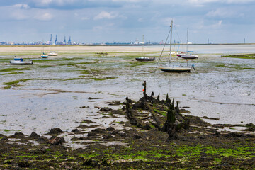 The River Medway at low tide at Upchurch, Kent revealing a boat wreck