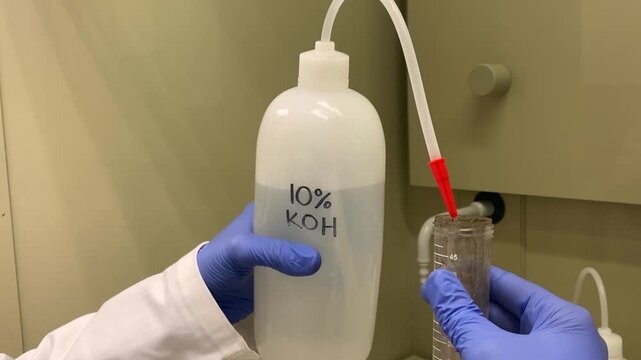 Potassium Hydroxide being poured into test tube
