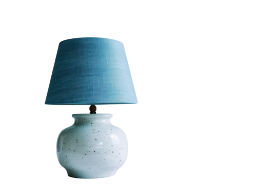 A serene table lamp with a textured blue shade illuminating a minimalist space in soft light during the evening hours isolated on transparent background