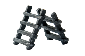 Miniature black ladders standing against a plain background, showcasing craftsmanship and design intricacy in a studio setting isolated on transparent background