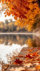 Autumn leaves hanging over peaceful lake and fallen foliage on dock, creating tranquil fall scene with copy space for banner, seasonal retreat or nature concept