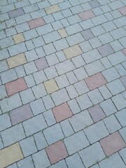 Texture of street tiles. Pattern of gray sidewalk tiles close up