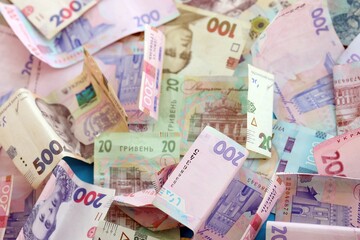 Big amount of different Ukrainian hryvnia money bills. Pile of crumpled ukrainian banknotes