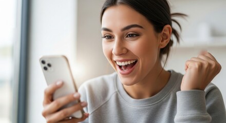 Ecstatic young woman celebrating an incredible online win on her smartphone. A joyful female feeling euphoric receiving good news.