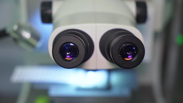 Close-up of microscope lenses. Microscope - front view. Medical equipment for scientific research in the field of medicine, as well as nanotechnology developments.