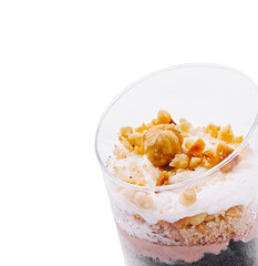 Delicious dessert in a clear cup with creamy layers and crunchy toppings