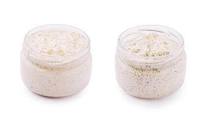 Varieties of creamy dips in clear jars displayed on a neutral background