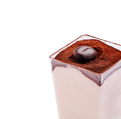 Creamy tiramisu dessert topped with cocoa and coffee bean in a clear glass