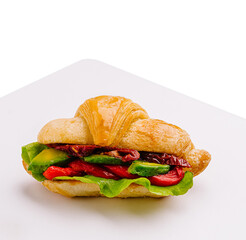 Delicious croissant sandwich with fresh vegetables and cheese slice