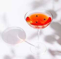 Elegant cocktail with cherries garnished in a stylish glass