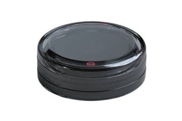Circular, dark gray device with transparent cover, red dot