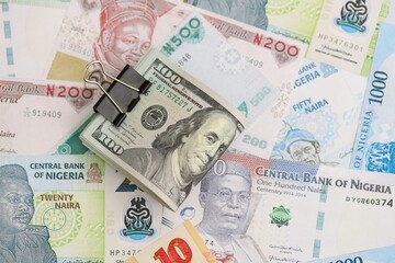 Nigerian naira currency money bills and bunch of us dollar banknotes. The concept of economics and currency exchange