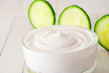 Skin Cream With Cucumber Slices, White Wooden Table