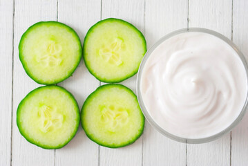 Skin Cream With Cucumber Slices, White Wooden Table