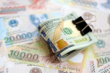 Vietnamese dong currency money bills and bunch of us dollar banknotes. The concept of economics and currency exchange