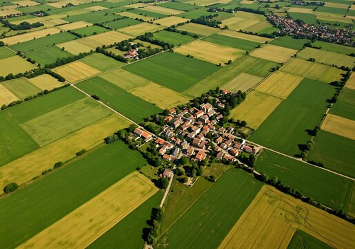 Aerial View of a Quaint Village Nestled Amidst Cultivated Fields. Generative Ai