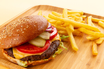 Perfect hamburger, classic burger, american cheeseburger with cheese and fries.