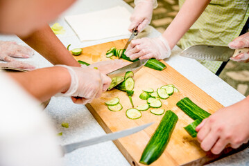Chef restaurant kitchen prepare vegetable salad, close up cut tomato cucumber