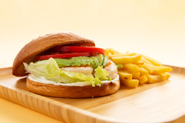 Shrimp and avocado sandwich. Burger. and fries.