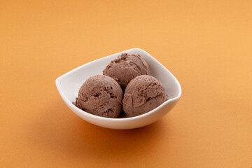 Three scoops of ice cream in a bowl.