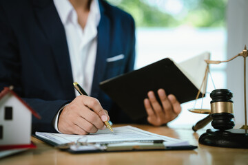 A gavel symbolizes law, justice, and authority in business and real estate auctions, representing contracts, ownership, finance, property sales, and legal agreements.