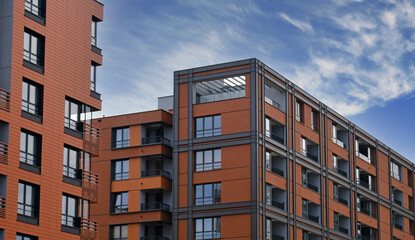Exterior of ​​modern houses in new area of the city. Architectural detail of windows, balconies. Real estate, residential apartment and office building architecture