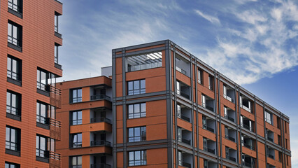 Fototapeta premium Exterior of ​​modern houses in new area of the city. Architectural detail of windows, balconies. Real estate, residential apartment and office building architecture