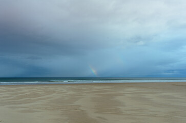 A distant rainbow in the Atlantic Ocean:: Portstewart Strand, County Derry, Northern Ireland 