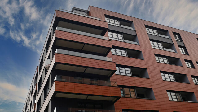 Exterior of ​​modern houses in new area of the city. Architectural detail of windows, balconies. Real estate, residential apartment and office building architecture