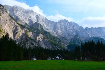 Cliff above Tamar mountain lodge next to a meadow in Gorenjska, Slovenia