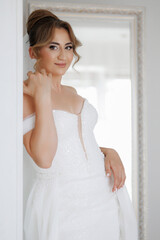 Bridal portrait of a woman in a stunning wedding gown in a bright and elegant setting