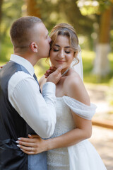 Fototapeta premium Couple shares an intimate moment in a beautiful outdoor setting during their wedding ceremony