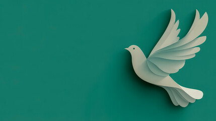 Fototapeta premium White paper dove flying on green background representing peace and hope