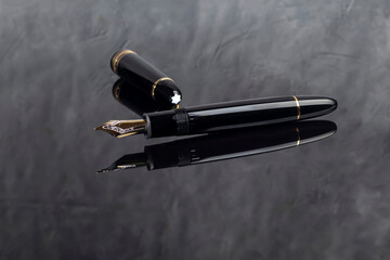 Fountain pen on dark marble background. Rare writing instruments.