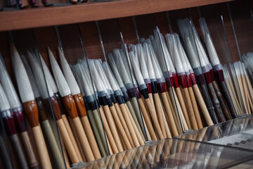 Calligraphy tassels on shelf in a store