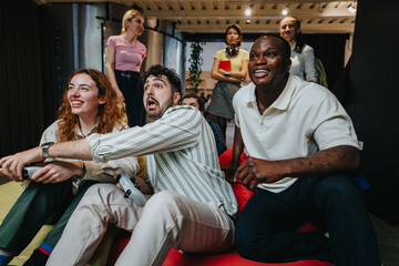 Young adults playing and enjoying a video game indoors in a casual and lively setting, expressing...