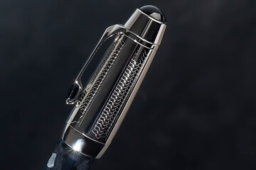 Fountain pen on dark marble background. Rare writing instruments.