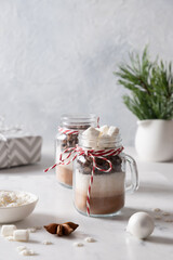Christmas edible gift in mason jar for chocolate beverage on white background. Close up. Xmas festive dessert. Vertical format.