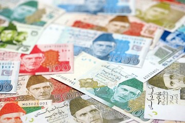 Pakistan rupees banknotes. The current Pakistan money bills lies on table in big amount