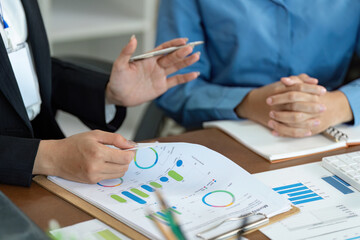 Business Discussion. Professionals analyzing financial reports and engaging in conversation.