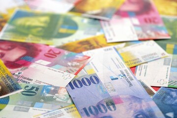 Swiss franc banknotes. The current francs money bills lies on table in big amount