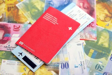 Swiss franc banknotes and passport with tickets. The current francs money bills and biometrical pass