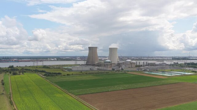 Drone panorama of Doel Nuclear Plant towers with smoke rising, Belgium