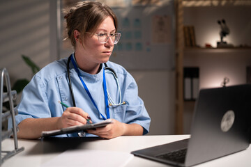 physician nurse diagnosis disease working over hours filling paper medical records doing paperwork...