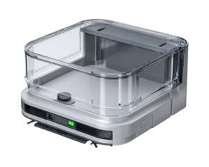 Square, transparent-lidded, white-gray appliance.  Compact, boxy design with clear plastic top and sides.  A dark gray inner compartment.  Small, light-emitting components visible