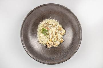 Creamy mushroom risotto with parmesan cheese served on a dark plate