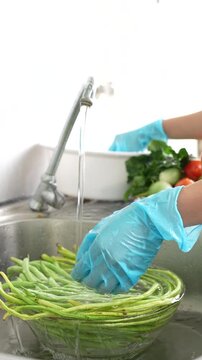 Close-up of a woman washing vegetables