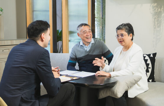 professional sales man business insurance or financial advisor talk meeting individual senior focus discussion around table document modern office.suggesting financial plan or investment strategy.